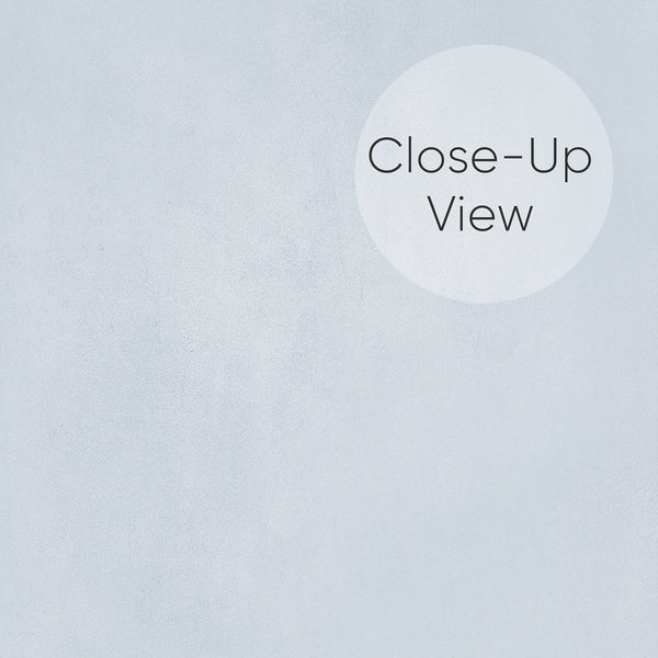 Matte pale blue wallpaper with cloud-like strokes and soft mottling, perfect for creating a serene backdrop in modern or Japandi-style spaces.