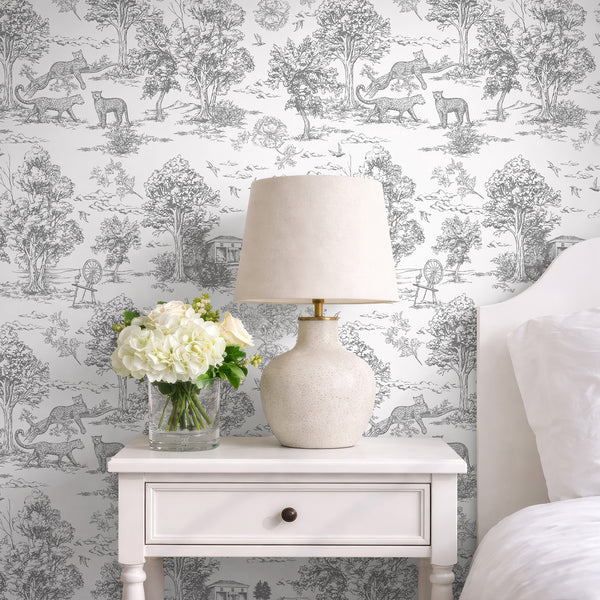Close-up of French toile motifs with leopards and birds on a white ground, offering a classic, refined look for eclectic or French country spaces. The pre-pasted wallpaper's finely engraved details add a touch of sophistication to hallways or living rooms.