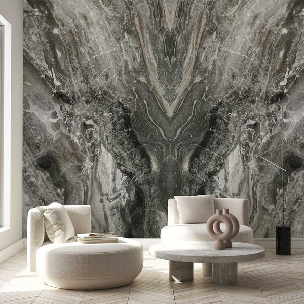 Close-up of bookmatched marble wallpaper featuring bold charcoal and taupe chevron veins on a creamy white surface. This wall mural offers an upscale, stone-like appearance perfect for dining rooms or offices. Made in the USA with eco-friendly materials, it's a temporary, removable peel and stick option, suitable for creating a modern accent wall in home decor.