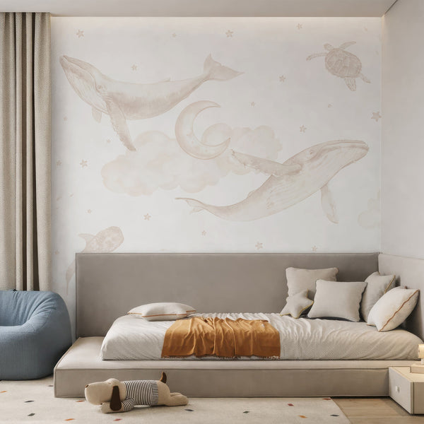Watercolor whale wallpaper in soft beige and cream tones with humpback whales, sea turtles, fish, stingray, clouds, moon and scattered stars.