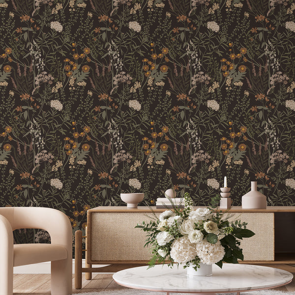 Close-up of Moody Dark Floral Wallpaper showing dense botanical illustrations on a dark backdrop. The intricate design with earthy tones like olive green and warm rust is perfect for cottagecore bedrooms or studies, offering eco-friendly materials and easy repositioning.