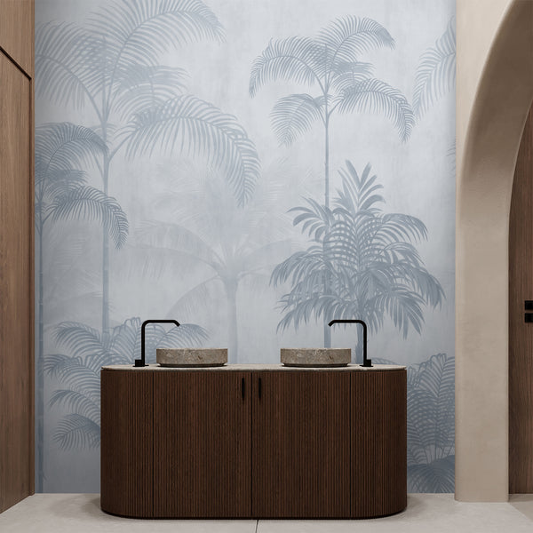 Neutral blue palm tree wallpaper with an airy tropical landscape of tall palms and delicate foliage for a bedroom accent wall or living room.