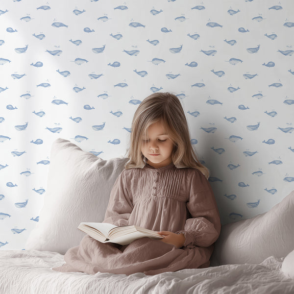 Watercolor whale nursery wallpaper with a sweet blue sea animal and playful splashes, ideal for a baby boy bedroom or coastal kids room.