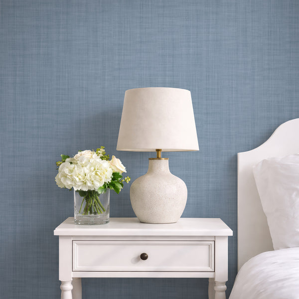 Dusty blue linen texture wallpaper with a subtle plaid-like weave, perfect for modern minimalist or coastal interiors. The muted tone and crosshatch striations create a calm backdrop ideal for bedrooms or living rooms. Removable peel and stick options available, eco-friendly and easy to apply.