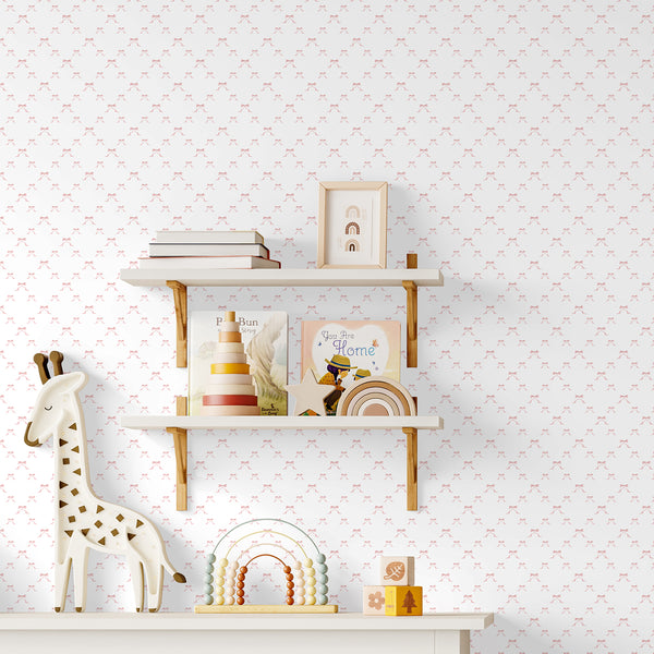 Soft pink bow wallpaper featuring delicate watercolor ribbons with flowing tails on a clean white background for a sweet baby girl nursery.