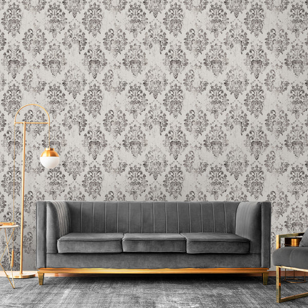 Distressed charcoal damask motifs on a warm gray background provide a vintage aesthetic. This eco-friendly wallpaper is perfect for elegant formal dining rooms or bedrooms, blending well with traditional decor.