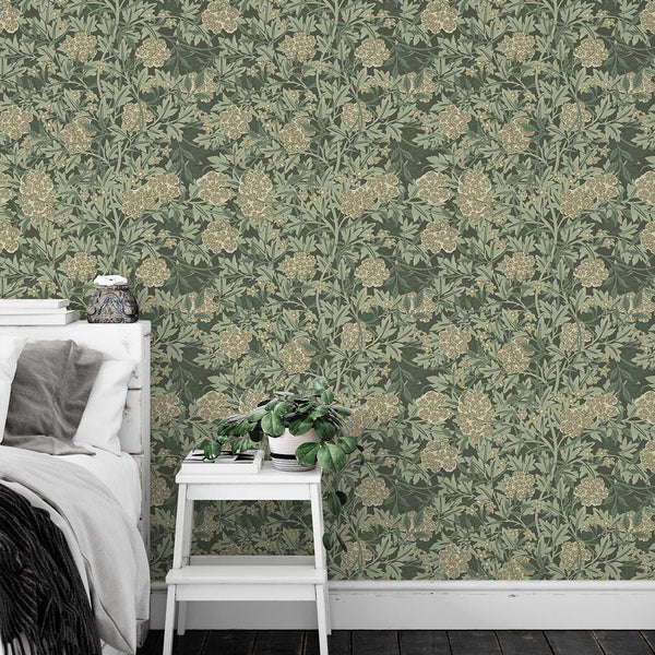 Green Jasmine wallpaper by Morris featuring dense floral repeats with beige blooms and layered foliage. Ideal for traditional dining rooms, providing a heritage-inspired look with graphic detailing.