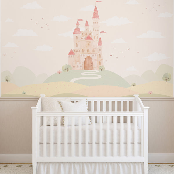 Fairytale castle wallpaper with a tall pink and beige princess castle, soft green hills, winding path and dreamy clouds for a girls bedroom or nursery.
