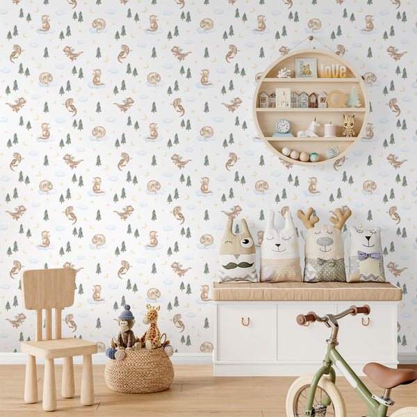 Whimsical dragon nursery wallpaper with soft brown, blue and green watercolor details, featuring a baby dragon, forest trees, clouds, moon and stars.