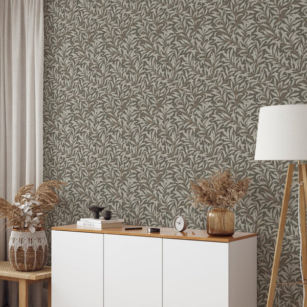 Botanical wallpaper featuring dense willow motifs and warm brown accents, offering a serene vibe for living rooms. Made in the USA, this wallpaper is designed for easy removal and repositioning.