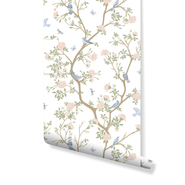 Blossom Tree wallpaper with pink blossoms, green leaves, and blue birds on a white background. This removable botanical wallpaper provides a light, airy feel for nurseries or home offices seeking a gentle painterly touch.