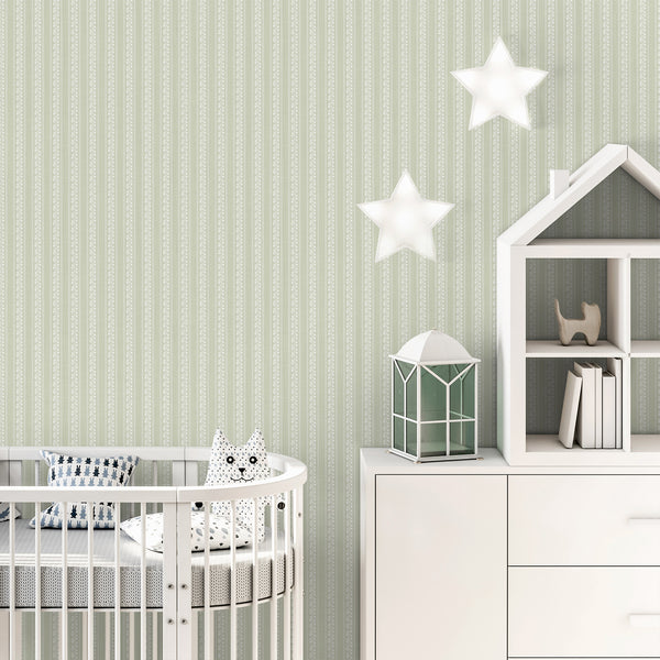 Sage green nursery wallpaper featuring hand-drawn white floral vines, narrow decorative stripe borders, and a calming botanical pattern for children's rooms.