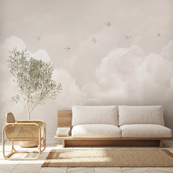 Soft beige cloud wallpaper with delicate flying birds and layered white clouds, creating a dreamy neutral wall mural for a nursery or kids bedroom.