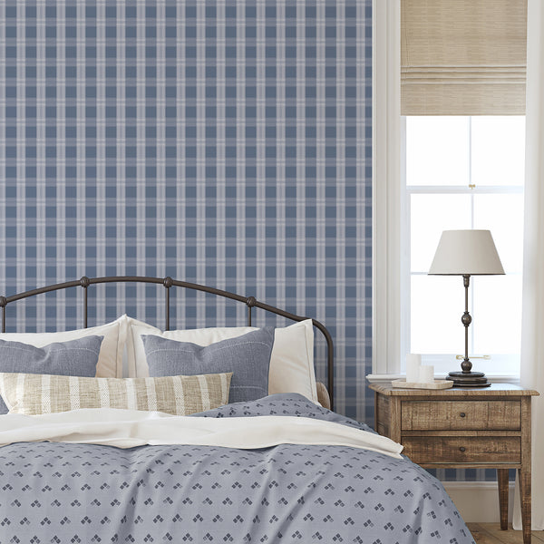 Preppy blue wallpaper featuring a large-scale check pattern with delicate pale stripes for bedrooms, nurseries, home offices, and living spaces.