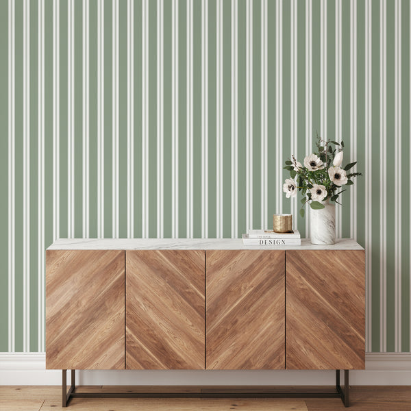 Modern farmhouse wallpaper in muted green and white with refined vertical stripes, creating a clean backdrop for nurseries and elegant interiors.