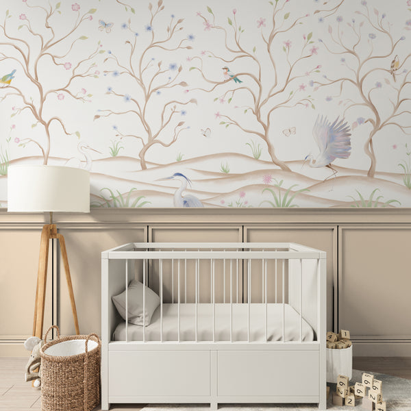 White floral wallpaper featuring elegant flowering trees, heron birds, butterflies and soft green botanical details for a bedroom or living room.