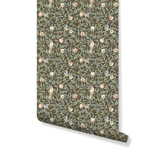 Bird & Pomegranate wallpaper by Morris, featuring songbirds and pomegranates on a deep brown ground. The tight, textile-like repeat with sage foliage and red fruit adds heritage charm to traditional interiors. Ideal for hallways or living rooms, this pre-pasted wallpaper offers a rich, vintage appeal, perfect for maximalist decor.