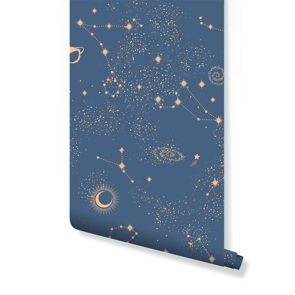 Dreamy Blue Sky & Constellation wallpaper featuring peach stars and crescent moons on a navy background, perfect for a nursery accent wall. This removable, eco-friendly wall mural is ideal for renters seeking an easy-to-apply celestial theme in a kids' room or home office.