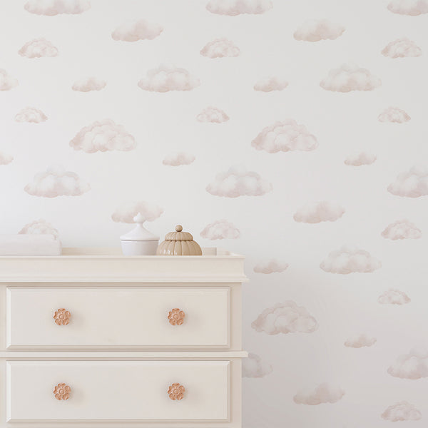 Blush beige watercolor cloud wallpaper featuring soft layered cloud shapes on a bright white background for a dreamy baby girl nursery.