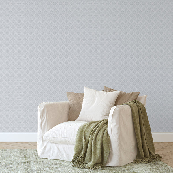 Gray blue damask wallpaper displaying floral medallions with low-contrast edges, ideal for a subtle, vintage look in bedrooms or entryways.