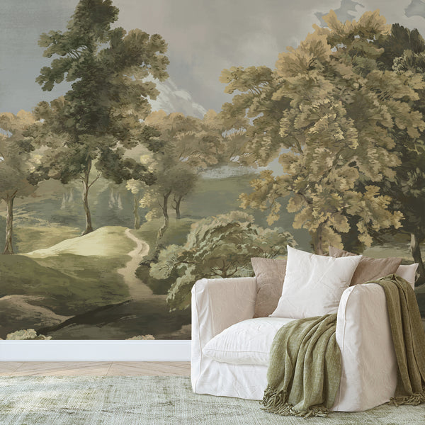 Olive green forest wallpaper with painterly trees, distant mountains and a scenic countryside path for an elegant living room accent wall.