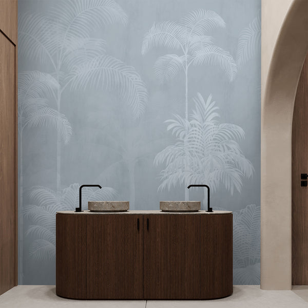 Light blue tropical wall mural featuring graceful white palm trees and softly faded botanical foliage for a minimalist modern bedroom.