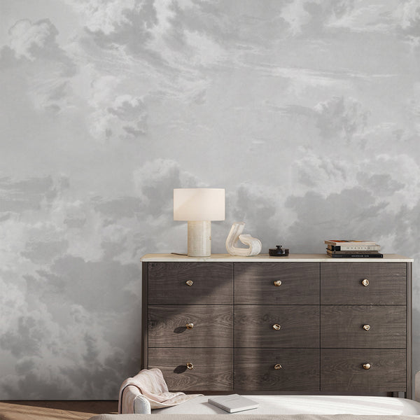 Neutral gray removable wallpaper featuring soft cloud formations and an ethereal sky design, perfect for a nursery, bedroom, or kids room accent wall.