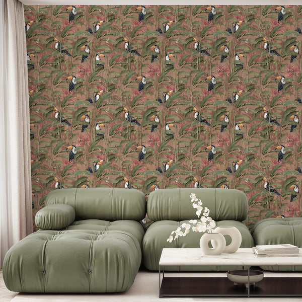 Pink jungle peel and stick wallpaper featuring exotic toucan birds perched among tropical plants and banana leaves for a vibrant bedroom accent wall.