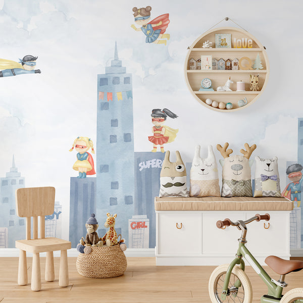 Superhero nursery wallpaper featuring diverse watercolor heroes, blue skyscrapers, fluffy clouds, colorful capes, and whimsical comic-inspired details.