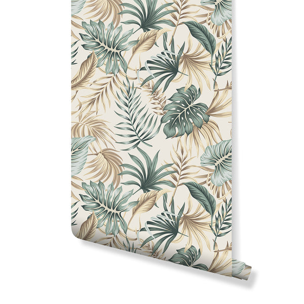 Lush tropical palm leaves wallpaper in muted teal and sage green, featuring large monstera and banana leaves with sandy beige accents on a soft cream background. Ideal for living rooms and bedrooms, this removable peel and stick wall mural offers a relaxed resort vibe with eco-friendly materials, perfect for modern coastal interior design.