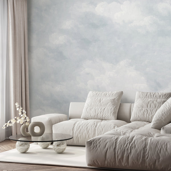 Light blue removable wallpaper with airy white clouds and a soft painted sky design, perfect for a nursery, bedroom, or modern kids room accent wall.