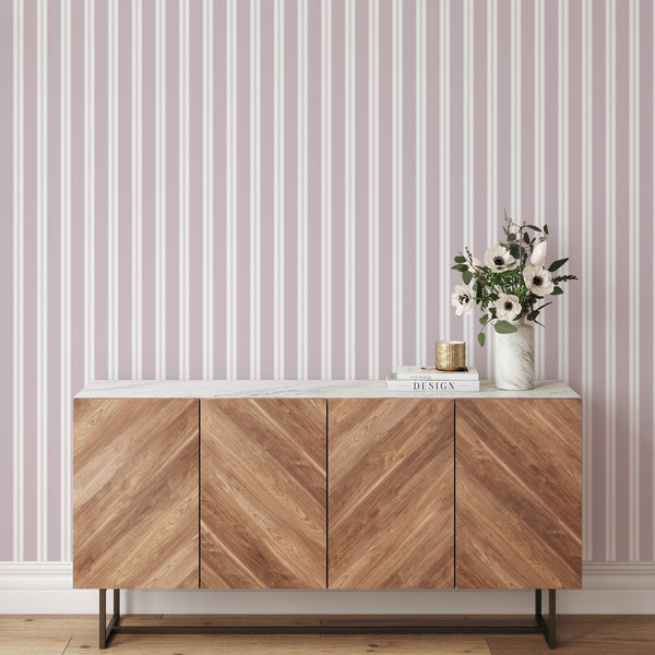 Preppy wallpaper in soft dusty mauve and white with refined vertical stripes, creating a stylish backdrop for nurseries and girls bedrooms.