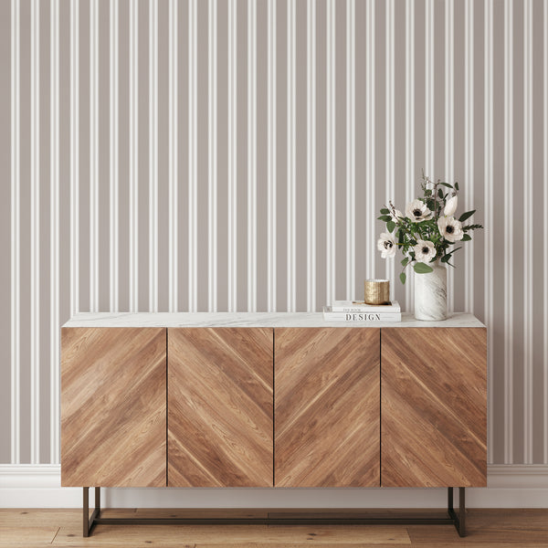 Minimalist neutral wallpaper featuring taupe vertical stripes, white panels, and delicate linear accents for modern living room or bedroom decor.