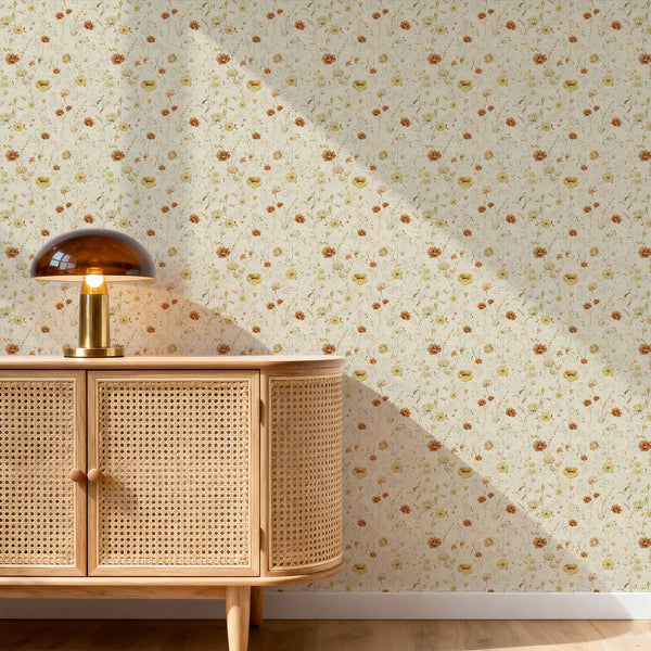 Vintage botanical wallpaper with small meadow flowers in warm terracotta, pale yellow and green over a textured beige background for a soft natural look.
