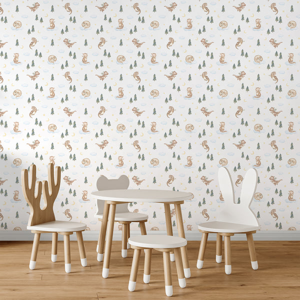 Cute dragon wallpaper with a soft watercolor baby dragon, blue clouds, green pine trees, golden stars and a crescent moon for a whimsical nursery.