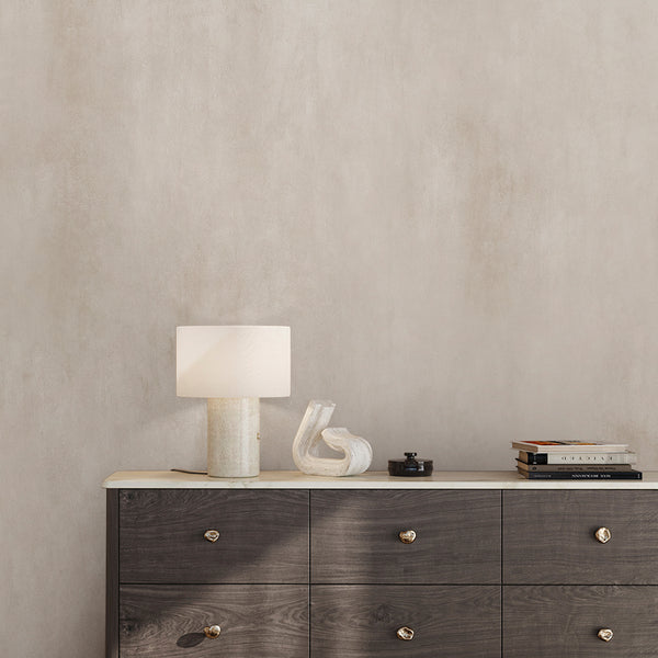 Close-up of Beige Plaster Wall Mural showcasing gentle vertical washes and blended tonal shifts with light taupe accents. The smooth, softly weathered character is perfect for home offices or hallways seeking understated decor. Temporary, self-adhesive wallpaper made in the USA, ideal for decorators and renters seeking a refined, textured wall covering.