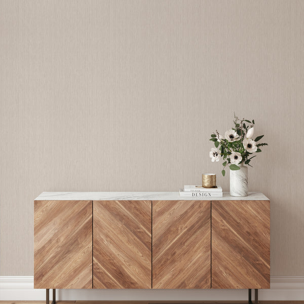 Beige vertical texture wallpaper with a natural woven look, enhancing the vertical emphasis in any space. Ideal for decorators, this removable wallpaper is made in the USA from eco-friendly materials, perfect for renters looking for temporary solutions.