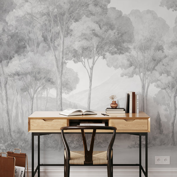 Close-up of gray misty forest wallpaper, showcasing watercolor grain and sketchy tree trunks for a gallery-like living room ambiance. This removable wall mural is made in the USA and perfect for a temporary accent wall.