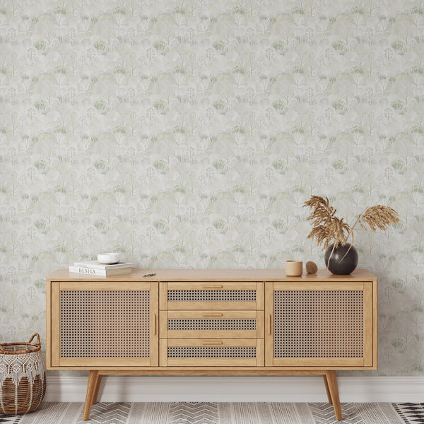 Scandinavian woodland wallpaper featuring abstract trees in pale sage, soft gray and beige with layered watercolor shapes and a subtle paper texture.