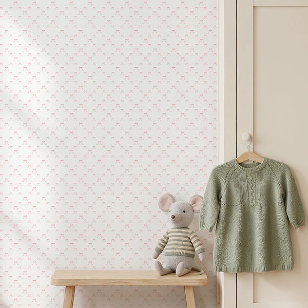 Coquette nursery wallpaper featuring evenly spaced pink bows with long ribbon tails on a bright white background for charming girls room decor.