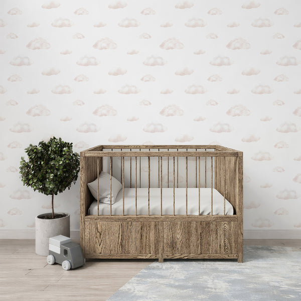 Minimalist cloud wallpaper with light pink and creamy watercolor tones on white, creating a soft whimsical look for modern nursery decor.