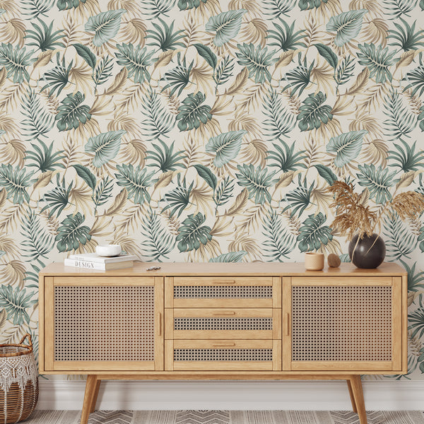 Tropical palm leaves wall mural showcasing layered monstera and fan palms in muted teal and sage, complemented by warm sandy beiges. The hand-illustrated pattern on a cream background provides a smooth matte finish, ideal for creating an airy, neutral accent wall in home offices and entryways. Made in the USA, it's easy to apply and reposition.