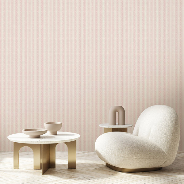 Soft pink botanical wallpaper featuring repeating floral stripe columns, fine line art flowers, and subtle woven texture for cottagecore nursery interiors.