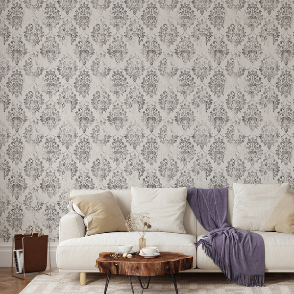 Warm gray damask wallpaper with distressed charcoal medallions, offering a vintage, rubbed effect. Perfect for adding an elegant touch to a bedroom or formal dining area, this traditional design enhances any classic interior.