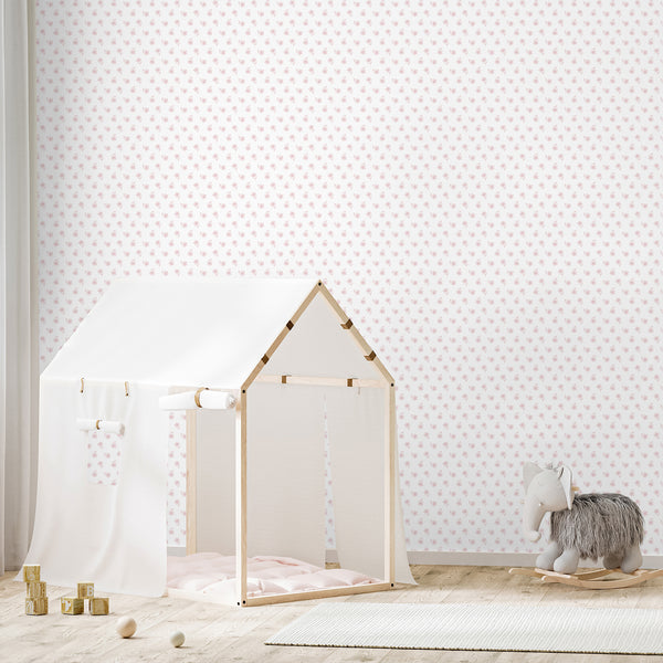Girls nursery wallpaper with soft pink hand sketched flowers in a simple repeating pattern, creating a delicate floral look for a baby girl room.