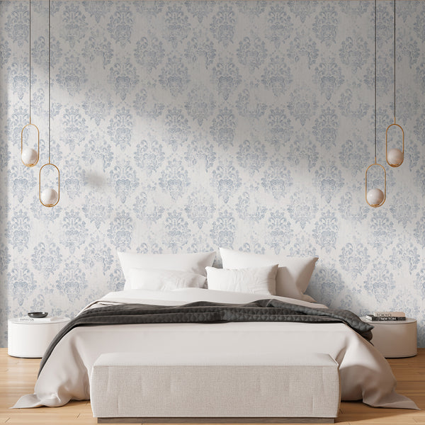 Blue-gray damask wallpaper with a worn-in look, enhancing a bedroom accent wall. Pre-pasted wallpaper, made from eco-friendly materials, ideal for renters.