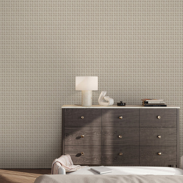 Weathered neutral wallpaper with repeating taupe floral damask motifs on a warm beige background, ideal for a bedroom or dining room accent wall.