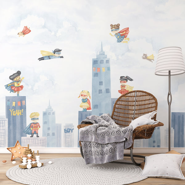 Watercolor superhero wallpaper featuring boys and girls flying above a soft blue city skyline with clouds, colorful capes, and playful comic details.