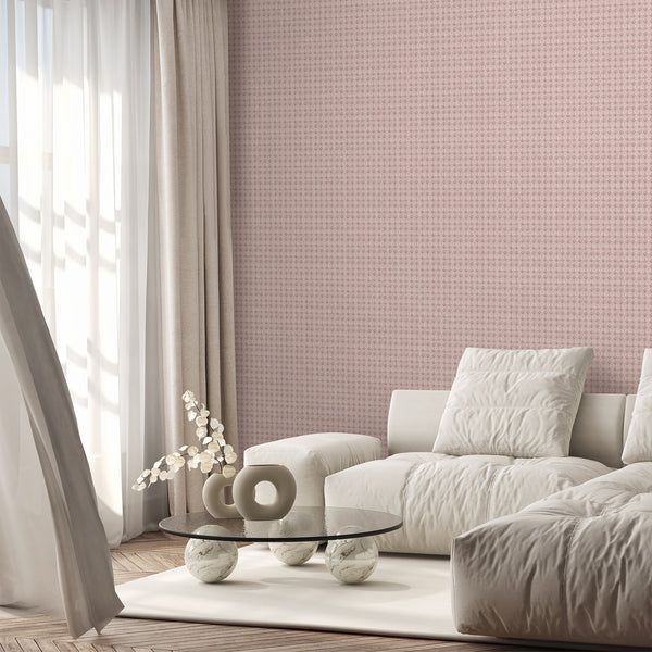 Distressed pink damask wallpaper with repeating floral motifs and muted dusty rose tones, ideal for an elegant bedroom or feminine living room accent wall.