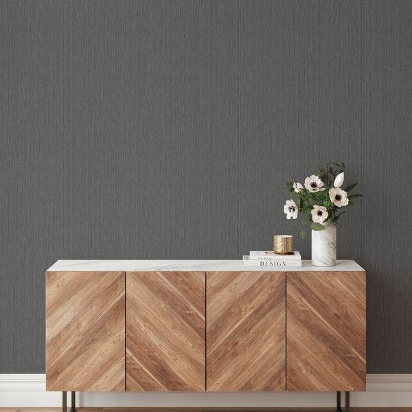 Matte dark gray wallpaper with a faint grain, perfect for a sophisticated home office. Traditional unpasted wallpaper, easy to reposition, made in the USA.